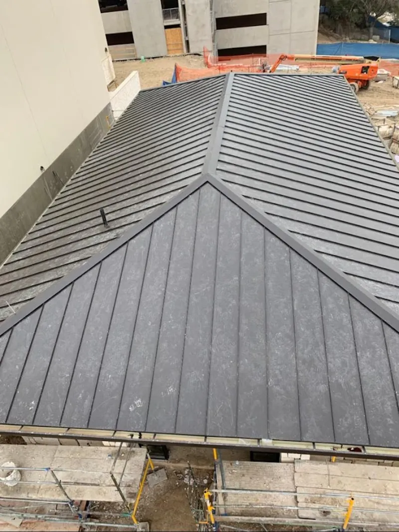 Commercial metal roof construction with crane equipment in Fruit Heights