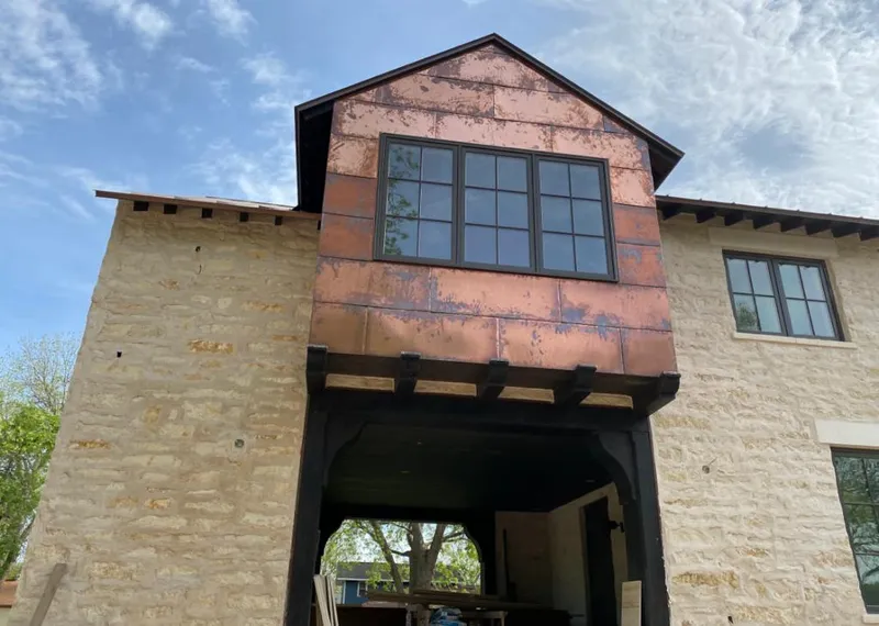 Copper metal panel facade on a stone building for Skylight Installation in Fruit Heights